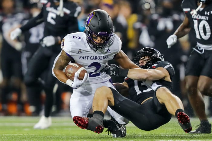 Nov 11, 2022; Cincinnati, Ohio, USA; Cincinnati Bearcats linebacker Ty Van Fossen (13) brings down East Carolina Pirates running back Keaton Mitchell (2) in the first half at Nippert Stadium. Mandatory Credit: Katie Stratman-USA TODAY Sports